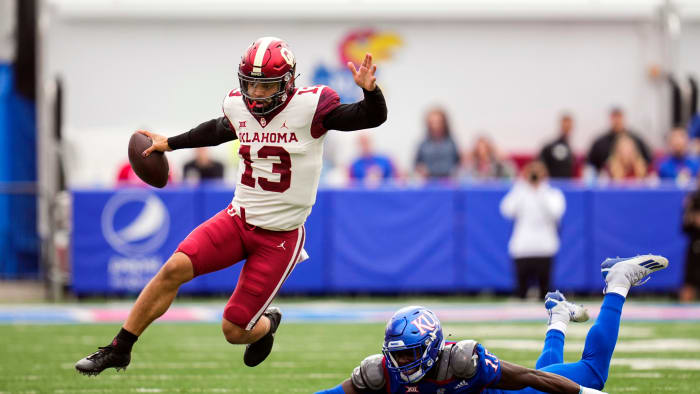 Oklahoma football's Caleb Williams escapes a Kansas defender.